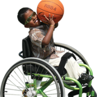 Child in wheelchair playing basketball