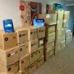 Image contains boxes of adult diapers that have been donated by a parent to AND