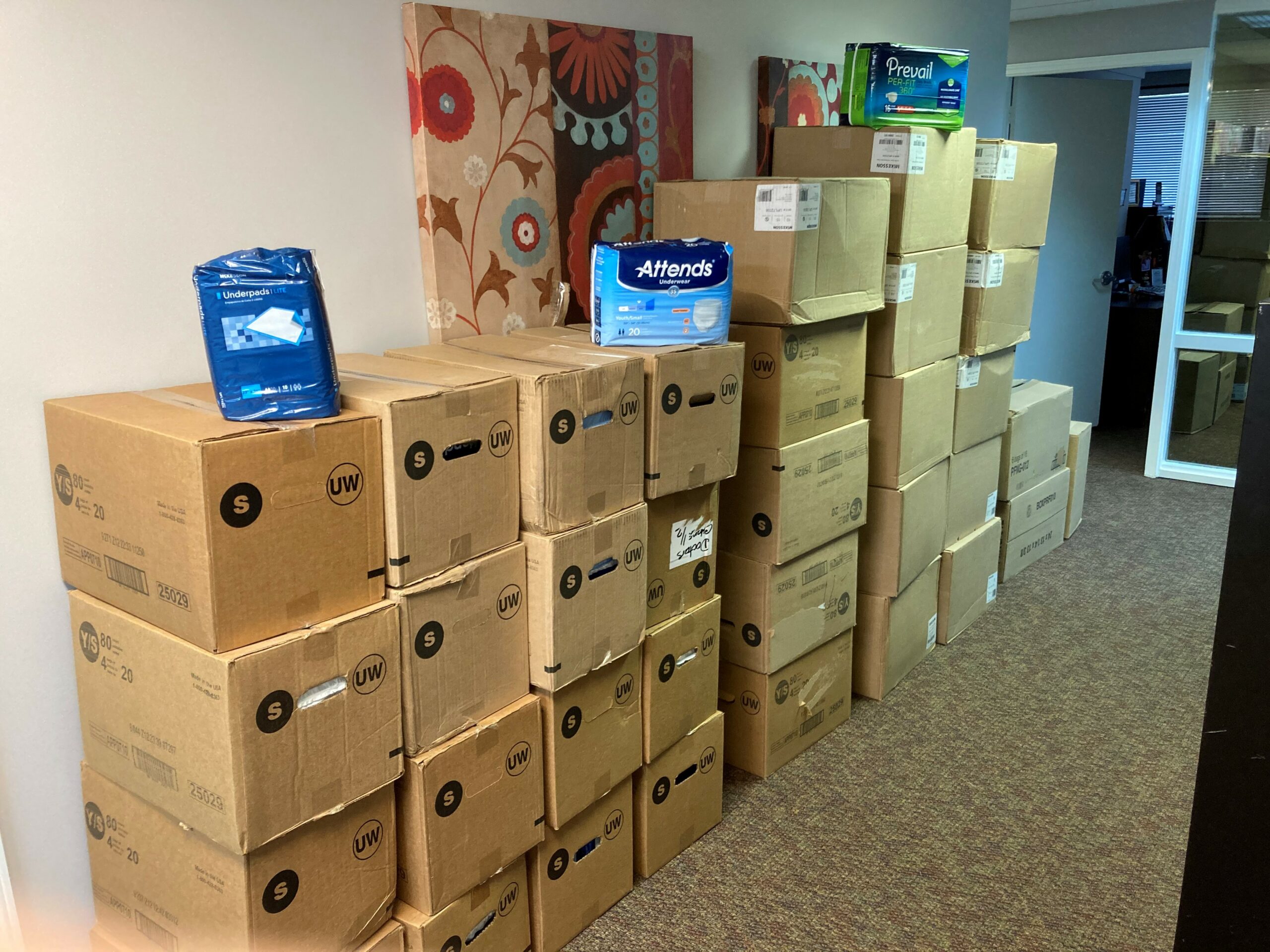 Image of boxes of adult diapers that have been donated by a parent to AND